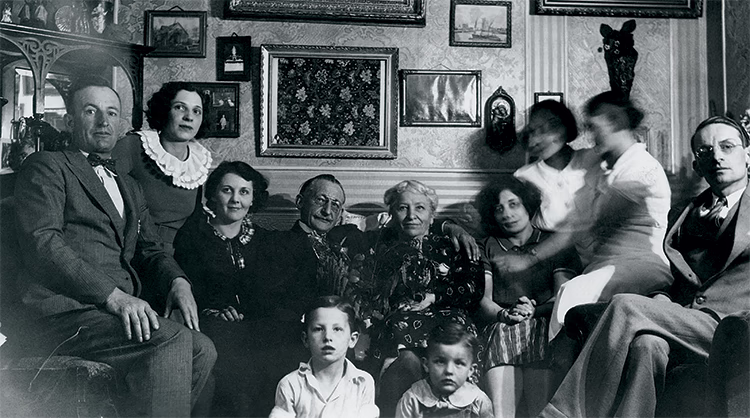 Photo en noir et blanc de trois générations de la famille Castelein prenant la pose.